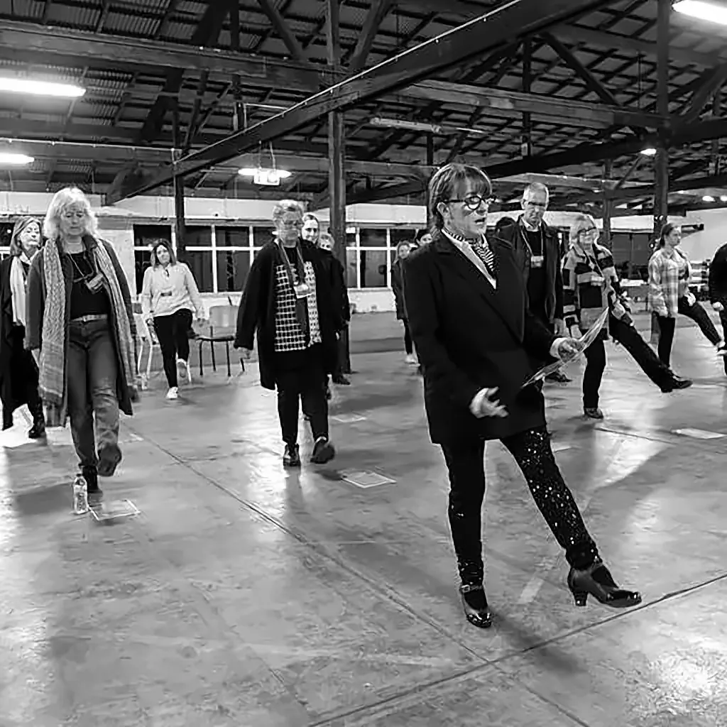 Participants stepping out a routine across the studio floor